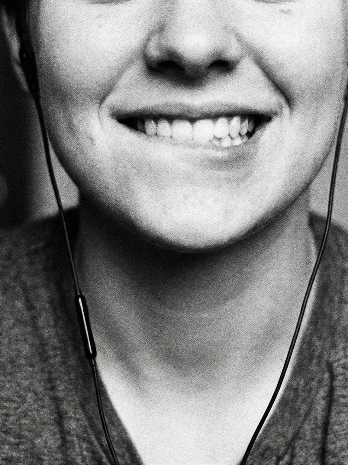 Jeune femme souriante car elle écoute un audio érotique amateur sur Murmures.